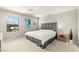 Sunlit bedroom boasting a stylish gray headboard, neutral tones, and large windows at 160 Lomita Heights Dr, Las Vegas, NV 89138