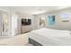 Bright bedroom featuring an adjacent balcony door, neutral tones, and a modern dresser at 160 Lomita Heights Dr, Las Vegas, NV 89138