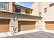 Exterior shot of a two car garage on a home with tan paint and a terracotta colored roof at 160 Lomita Heights Dr, Las Vegas, NV 89138
