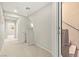 Well-lit hallway featuring neutral colored walls and carpets, and stairway to another floor at 160 Lomita Heights Dr, Las Vegas, NV 89138