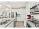 Contemporary kitchen with granite countertops, stainless steel appliances, modern lighting, and a convenient breakfast bar at 160 Lomita Heights Dr, Las Vegas, NV 89138