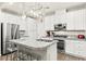 Stylish kitchen featuring stainless steel appliances, granite countertops, an island with bar stools, and ample storage at 160 Lomita Heights Dr, Las Vegas, NV 89138