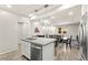 Beautiful open-concept kitchen with stainless steel appliances, island seating, and contemporary lighting fixtures at 160 Lomita Heights Dr, Las Vegas, NV 89138