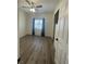 Bedroom features hardwood floors, ceiling fan, and large window at 1785 Puerto Way, Henderson, NV 89012