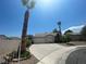 Single-story home with low maintenance desert landscaping, mature palm trees, and driveway leading to the garage at 1785 Puerto Way, Henderson, NV 89012