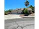 Charming single-story home featuring a low-maintenance yard, mature palm trees, and a two-car garage at 1785 Puerto Way, Henderson, NV 89012