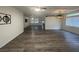 Open-concept living room with new luxury vinyl plank floors, natural light, and a modern ceiling fan at 1785 Puerto Way, Henderson, NV 89012