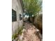 Exterior side yard has gravel ground and lush trees at 1785 Puerto Way, Henderson, NV 89012