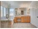 Bathroom has a walk-in shower, soaking tub, and a wooden vanity area at 2388 Kenneth Ave, Henderson, NV 89052