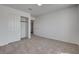Neutral carpeted bedroom with a closet and doorway, offering seamless transitions between rooms at 2388 Kenneth Ave, Henderson, NV 89052