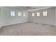 Spacious bedroom featuring neutral carpet, ceiling fan, and an array of windows letting in natural light at 2388 Kenneth Ave, Henderson, NV 89052