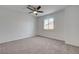 Neutral carpeted bedroom with a ceiling fan and a window showcasing natural light at 2388 Kenneth Ave, Henderson, NV 89052