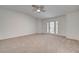 Bonus room features neutral carpet, a ceiling fan, and a doorway to the patio and backyard at 2388 Kenneth Ave, Henderson, NV 89052