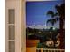 Las Vegas city views through the balcony of this home, featuring bright city lights and mature palm trees at 2388 Kenneth Ave, Henderson, NV 89052