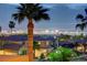 Expansive Las Vegas skyline views showcase the sparkling city lights from this desirable home, surrounded by palm trees at 2388 Kenneth Ave, Henderson, NV 89052