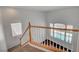 Entryway with hardwood railing offering a view of the home's soaring ceilings and sparkling pool at 2388 Kenneth Ave, Henderson, NV 89052