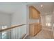 Upstairs hallway has carpet flooring and wooden cabinets for extra storage at 2388 Kenneth Ave, Henderson, NV 89052