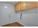 Functional laundry room features tile flooring, white door, and overhead cabinets at 2388 Kenneth Ave, Henderson, NV 89052