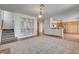 Open-concept living room with carpeted stairs, custom built-ins, and sight lines into the kitchen at 2388 Kenneth Ave, Henderson, NV 89052