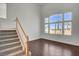 Bright living room featuring high ceilings, large windows, hardwood floors, and a staircase at 2388 Kenneth Ave, Henderson, NV 89052