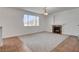 Cozy living room with plush carpeting, a fireplace, and a large window at 2388 Kenneth Ave, Henderson, NV 89052