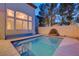 Backyard pool with water feature and large windows to the home's interior at 2388 Kenneth Ave, Henderson, NV 89052