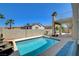 Backyard pool with stone waterfall feature and desert landscaping at 2388 Kenneth Ave, Henderson, NV 89052