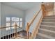 Bright stairway with carpeted steps, white banister, and natural wood trim leading to the upper level at 2388 Kenneth Ave, Henderson, NV 89052