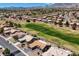Overhead shot of homes in a vibrant community next to a golf course with mountain views in the distance at 2625 Youngdale Dr, Las Vegas, NV 89134