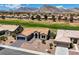 Picturesque aerial view of a home with a tile roof, desert landscaping, and a golf course in the background at 2625 Youngdale Dr, Las Vegas, NV 89134
