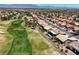 A beautiful aerial of a planned community beside a lush golf course; a great place to live and play at 2625 Youngdale Dr, Las Vegas, NV 89134