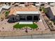 A picturesque shot of the home's backyard with an artificial lawn, desert plants, and covered patio at 2625 Youngdale Dr, Las Vegas, NV 89134