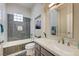 Modern bathroom with sleek bathtub, tiled shower, and stylish vanity with a large mirror at 2625 Youngdale Dr, Las Vegas, NV 89134