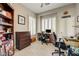 Bright home office with stylish desk, modern computer, white plantation shutters, and lovely decor at 2625 Youngdale Dr, Las Vegas, NV 89134