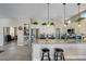 Bright kitchen featuring a large granite island, stainless steel appliances, and modern blue backsplash at 2625 Youngdale Dr, Las Vegas, NV 89134