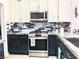 Close-up view of a well-equipped kitchen with stainless steel oven and gas range, granite counters, and sleek cabinetry at 2625 Youngdale Dr, Las Vegas, NV 89134