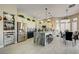 Spacious kitchen with stainless steel appliances, granite island with seating, and adjacent dining area at 2625 Youngdale Dr, Las Vegas, NV 89134