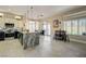 Modern kitchen featuring a large granite island, stainless appliances, tile floors, and open access to the backyard at 2625 Youngdale Dr, Las Vegas, NV 89134