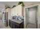 Stylish kitchen with stainless steel refrigerator, dark lower cabinets and blue backsplash at 2625 Youngdale Dr, Las Vegas, NV 89134