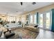 Spacious living room with modern furnishings, tile floors, and a view to the backyard at 2625 Youngdale Dr, Las Vegas, NV 89134