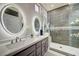 Modern bathroom with double vanity, granite countertop, and tiled glass shower at 2625 Youngdale Dr, Las Vegas, NV 89134