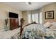 Comfortable main bedroom with dark wood furniture, ceiling fan and bright, shuttered windows at 2625 Youngdale Dr, Las Vegas, NV 89134