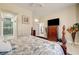 Comfortable main bedroom with dark wood furniture and view to the main bathroom at 2625 Youngdale Dr, Las Vegas, NV 89134