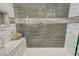 Walk-in shower features designer tile, built-in bench, and hexagon-tile floor at 2625 Youngdale Dr, Las Vegas, NV 89134