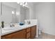 Bathroom featuring double sinks, a white countertop, and wooden cabinets at 2633 Chin Cactus Ct, Las Vegas, NV 89106