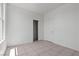 Bright bedroom featuring neutral walls, tile flooring, and a closet with shelving at 2633 Chin Cactus Ct, Las Vegas, NV 89106
