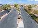 Gated community entrance featuring meticulously maintained landscaping, palm trees, and beautiful neighborhood views at 2633 Chin Cactus Ct, Las Vegas, NV 89106