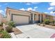 Charming single-story home with a two-car garage, desert landscaping, and a well-maintained front yard at 2633 Chin Cactus Ct, Las Vegas, NV 89106