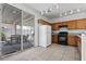 Functional kitchen features wooden cabinets, granite countertops, and a view to an outdoor dining space at 2633 Chin Cactus Ct, Las Vegas, NV 89106