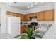 Efficient kitchen with wooden cabinetry, granite countertops, modern appliances, and a stainless steel sink at 2633 Chin Cactus Ct, Las Vegas, NV 89106